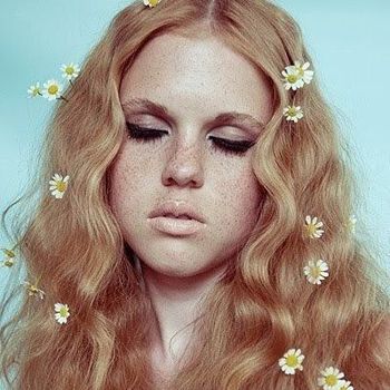 Woman with daisy flowers in her hair